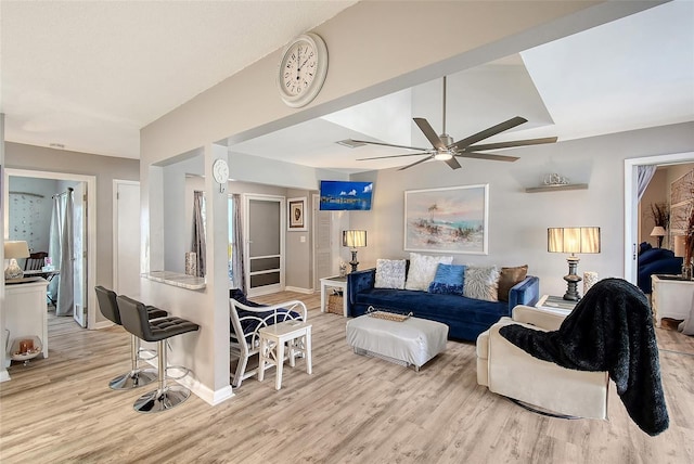 living room with ceiling fan and light hardwood / wood-style flooring