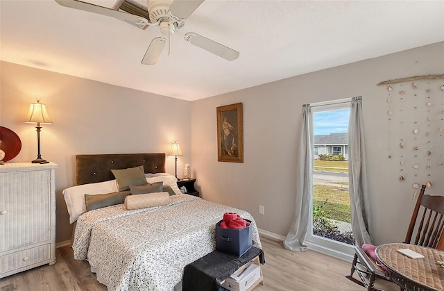 bedroom with ceiling fan and light hardwood / wood-style floors