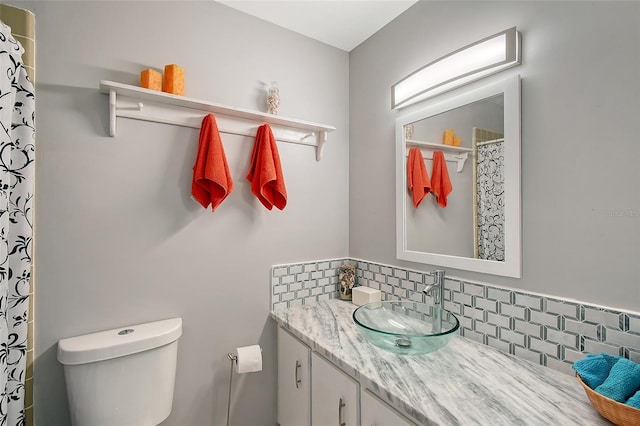 bathroom featuring decorative backsplash, toilet, and vanity