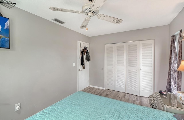 bedroom featuring a closet, ceiling fan, and hardwood / wood-style flooring