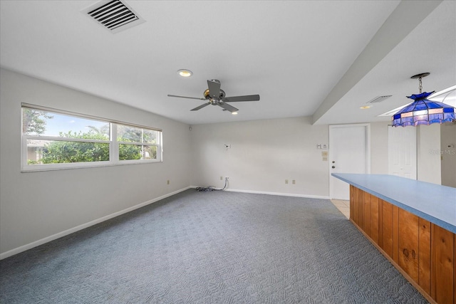 carpeted empty room featuring ceiling fan