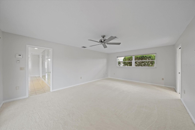 carpeted spare room with ceiling fan