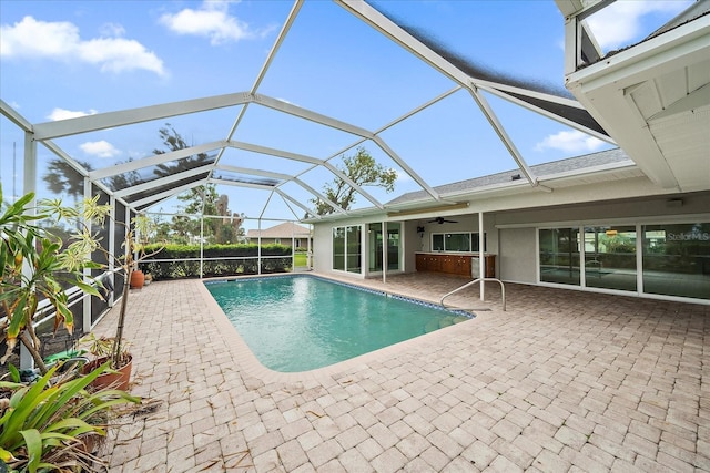 view of pool featuring a lanai, ceiling fan, and a patio