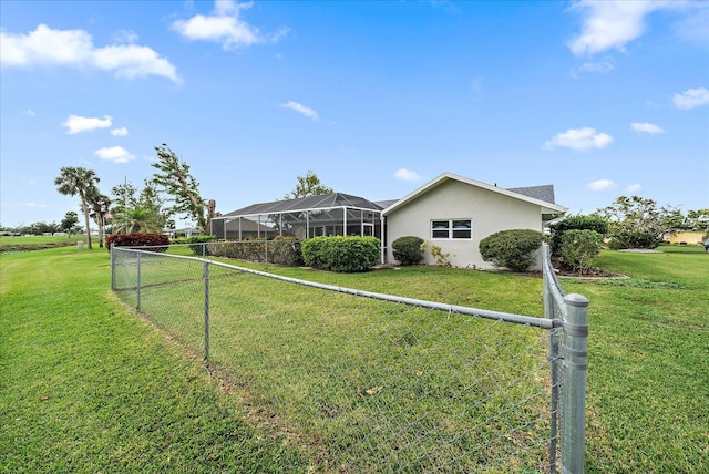 exterior space featuring a lawn and a lanai