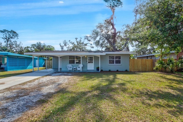 ranch-style home featuring a front yard and a carport