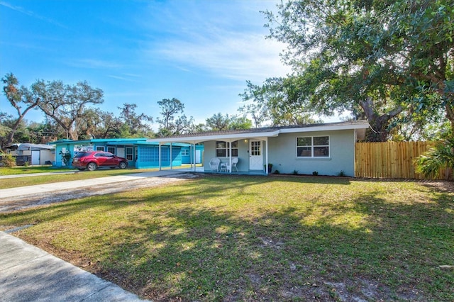 ranch-style house with a front yard and a carport