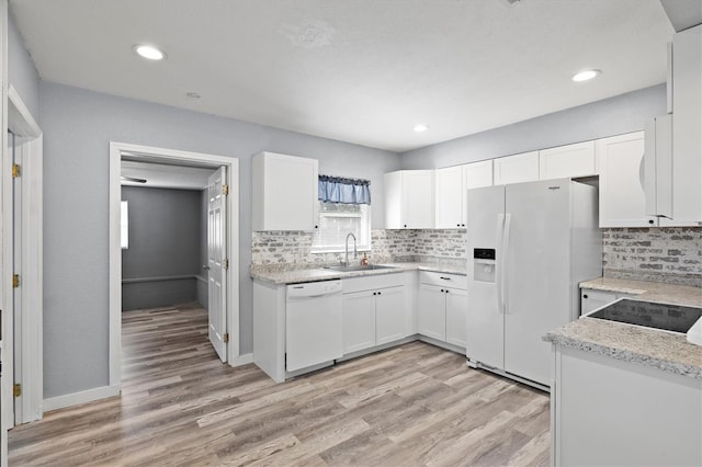 kitchen featuring light wood-type flooring, white appliances, white cabinetry, and sink