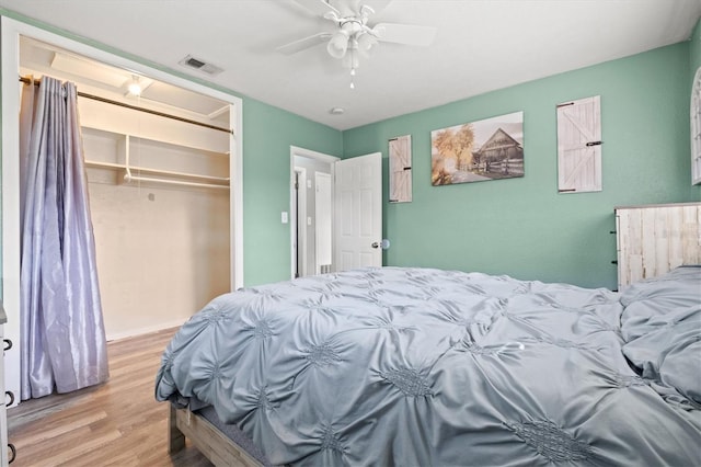 bedroom featuring ceiling fan, a closet, and light wood-type flooring