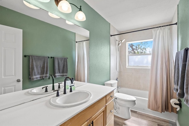 full bathroom with shower / tub combo, vanity, hardwood / wood-style flooring, and toilet