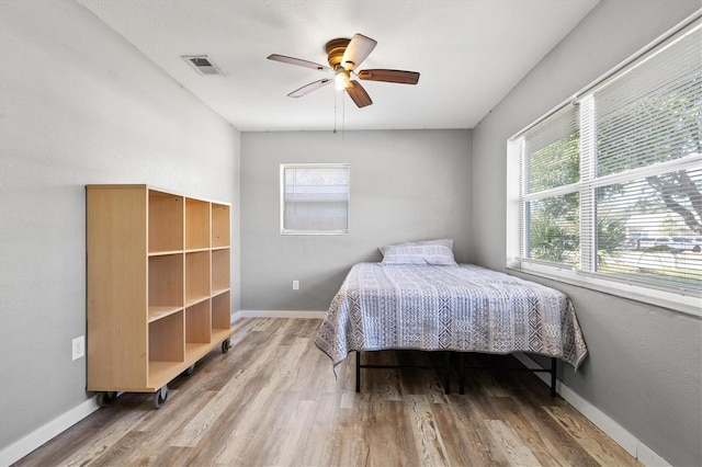 bedroom with hardwood / wood-style flooring and ceiling fan