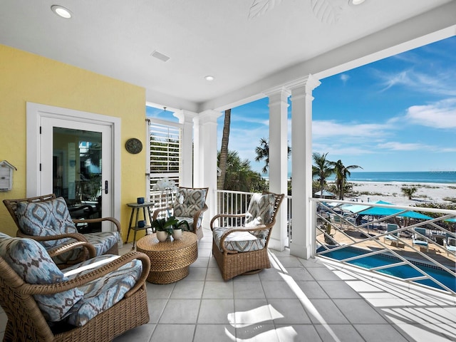 interior space featuring a view of the beach and a water view