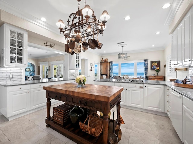 kitchen with kitchen peninsula, pendant lighting, and white cabinetry