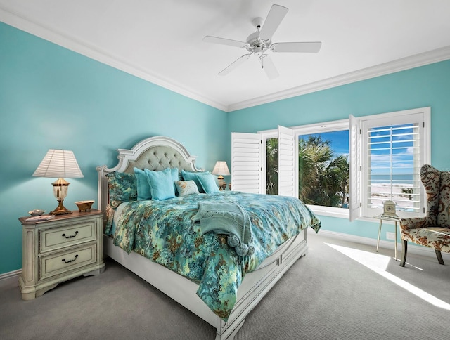 carpeted bedroom featuring ceiling fan and ornamental molding