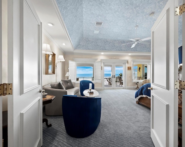 carpeted bedroom featuring ornamental molding, french doors, a raised ceiling, and access to exterior