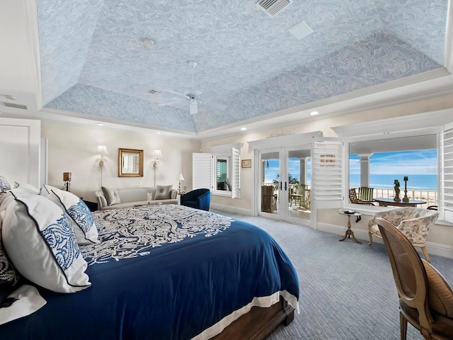 carpeted bedroom with a water view, french doors, a raised ceiling, access to exterior, and ornamental molding