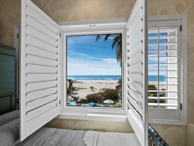 entryway with a beach view and a water view