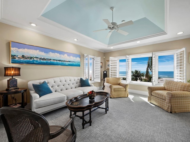 living area with crown molding, carpet, and a tray ceiling