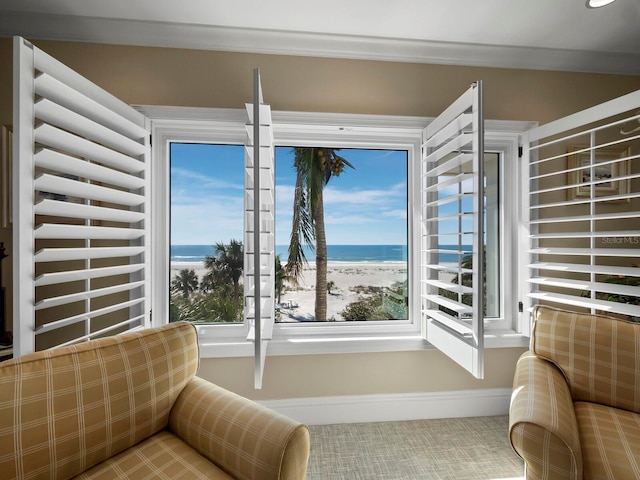 interior space with a beach view, a water view, and radiator heating unit