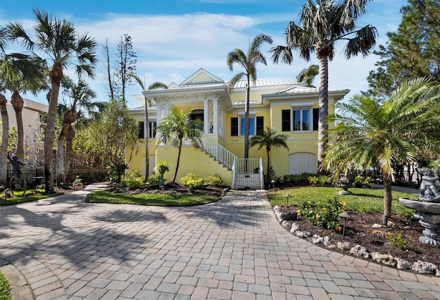 view of front of home with stucco siding and stairs