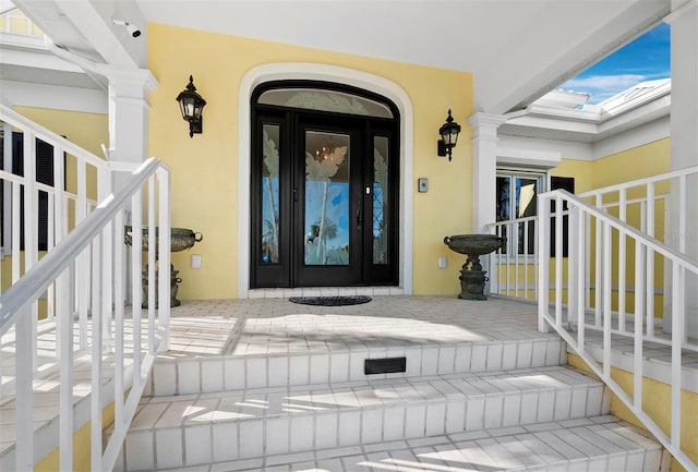 doorway to property featuring stucco siding