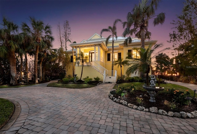 mediterranean / spanish-style home with stucco siding and decorative driveway