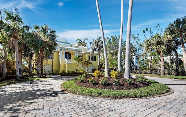 view of front of property featuring decorative driveway and stucco siding