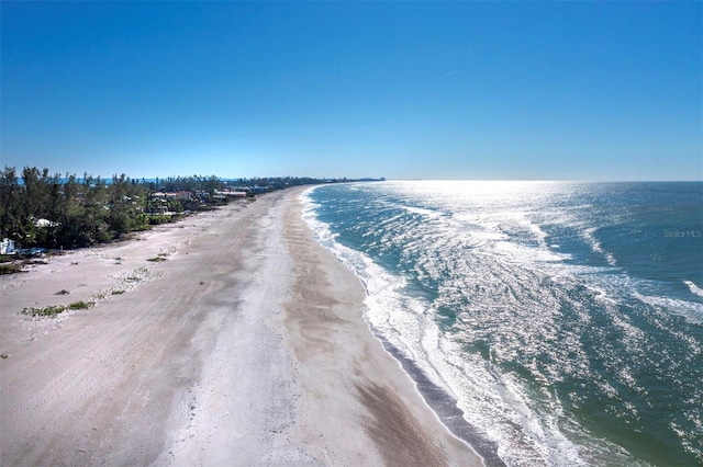 exterior space featuring a water view and a beach view