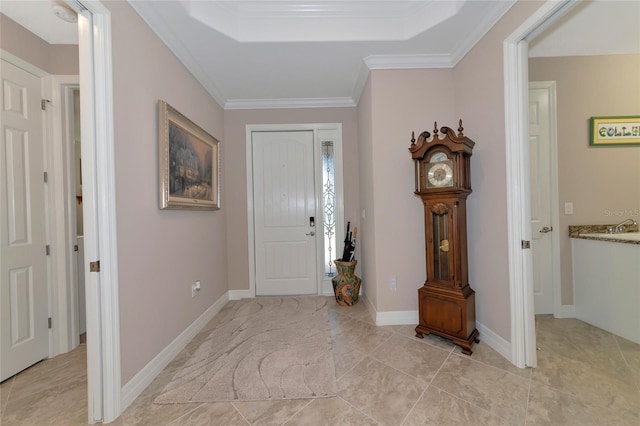 entrance foyer with light tile patterned floors, crown molding, and a tray ceiling