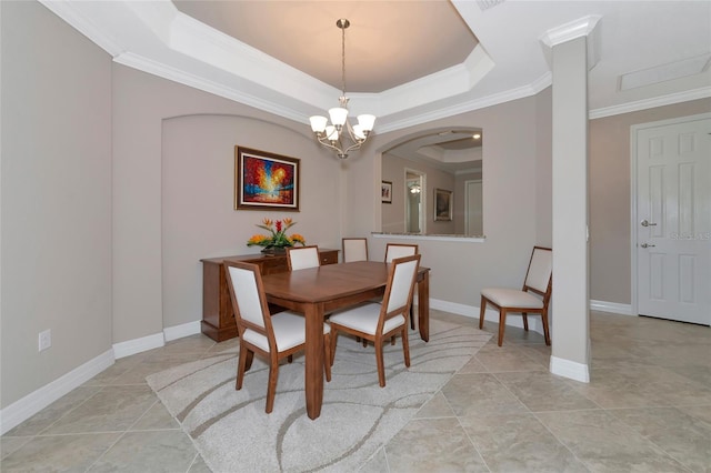 tiled dining room with a raised ceiling, crown molding, and a notable chandelier