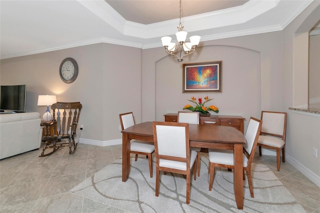 tiled dining room featuring an inviting chandelier, crown molding, and a tray ceiling