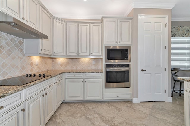 kitchen with oven, black electric cooktop, built in microwave, ornamental molding, and white cabinetry