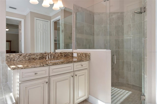 bathroom with walk in shower, vanity, and ornamental molding