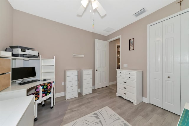 office space with light hardwood / wood-style floors and ceiling fan