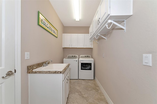 laundry area with washer and dryer, cabinets, and sink