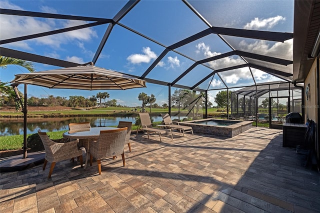 view of patio featuring glass enclosure, a water view, and an in ground hot tub