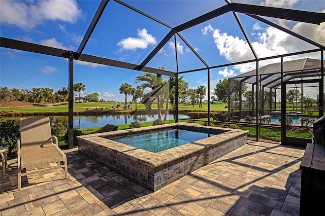 view of pool with glass enclosure, an in ground hot tub, a patio area, and a water view