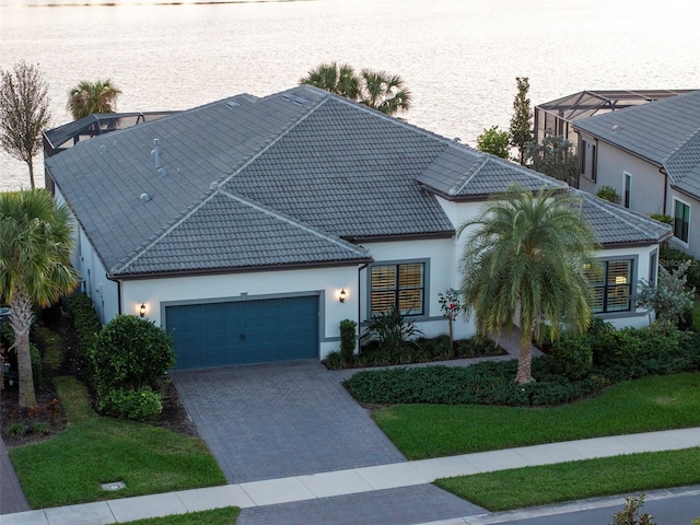 view of front of home with a front yard and a garage