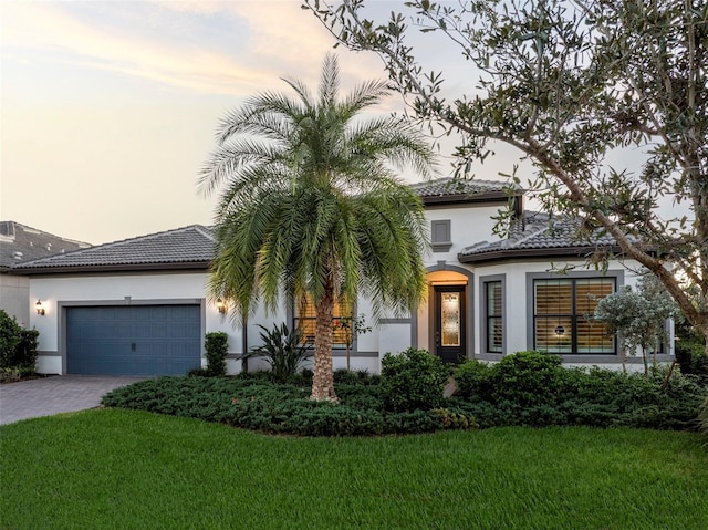 view of front of house with a lawn and a garage