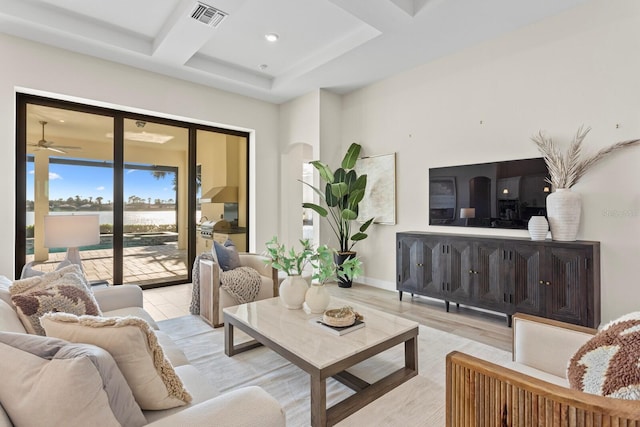 living room with ceiling fan, light hardwood / wood-style floors, beam ceiling, and coffered ceiling