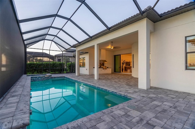 view of swimming pool with a lanai, a patio, and an in ground hot tub