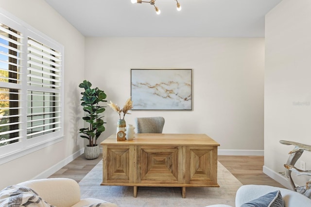 office featuring light hardwood / wood-style flooring and a chandelier