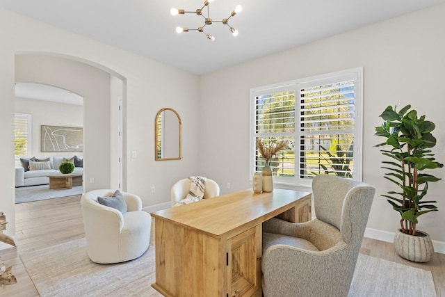 office space featuring a notable chandelier and light hardwood / wood-style flooring