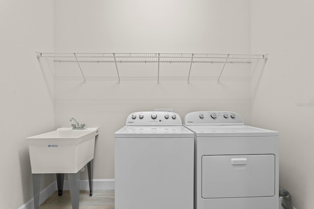 laundry area featuring independent washer and dryer and sink