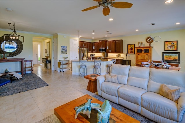 living room featuring light tile patterned floors, ceiling fan, and ornamental molding