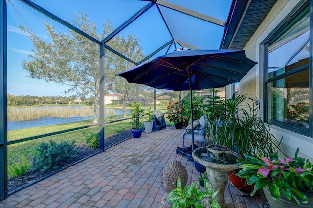 unfurnished sunroom featuring a water view