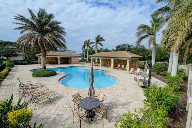 view of swimming pool with a patio area and an outdoor structure