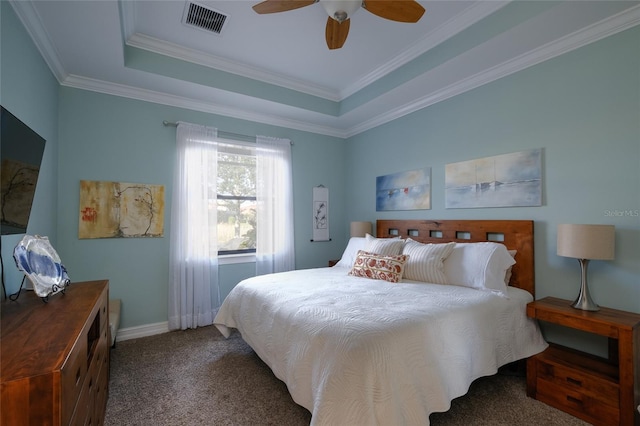 bedroom with ceiling fan, a raised ceiling, carpet floors, and crown molding