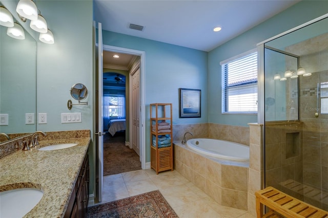 bathroom with tile patterned flooring, shower with separate bathtub, vanity, and a healthy amount of sunlight