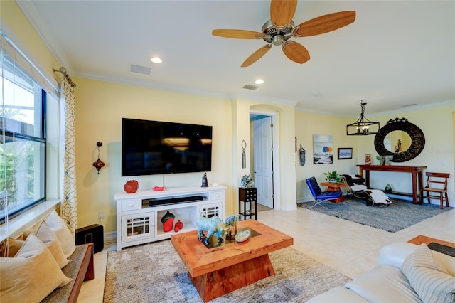 tiled living room featuring ceiling fan with notable chandelier and crown molding