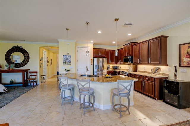 kitchen with a breakfast bar, crown molding, light tile patterned floors, decorative light fixtures, and stainless steel appliances